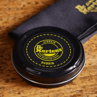 dr martens dubbin lying on table along with doc martens cloth