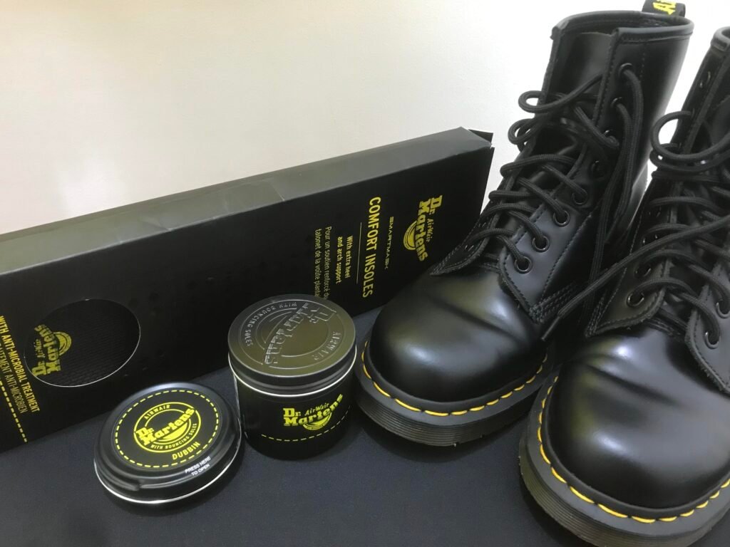 dr marten's dubbin and wonder balsamon a table with doc martens boots