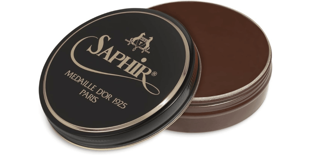 saphir brown shoe polish can with half cap open on white background